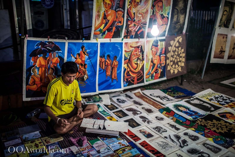 Boy Selling Art at Luang Prabang Market Photo Ooaworld