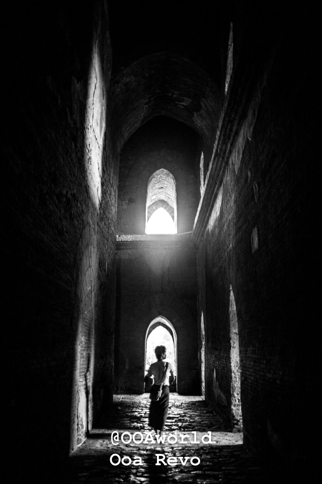 Bagan People Part I Bagan silhouette of person walking through ancient stone hallway Photo OOAworld