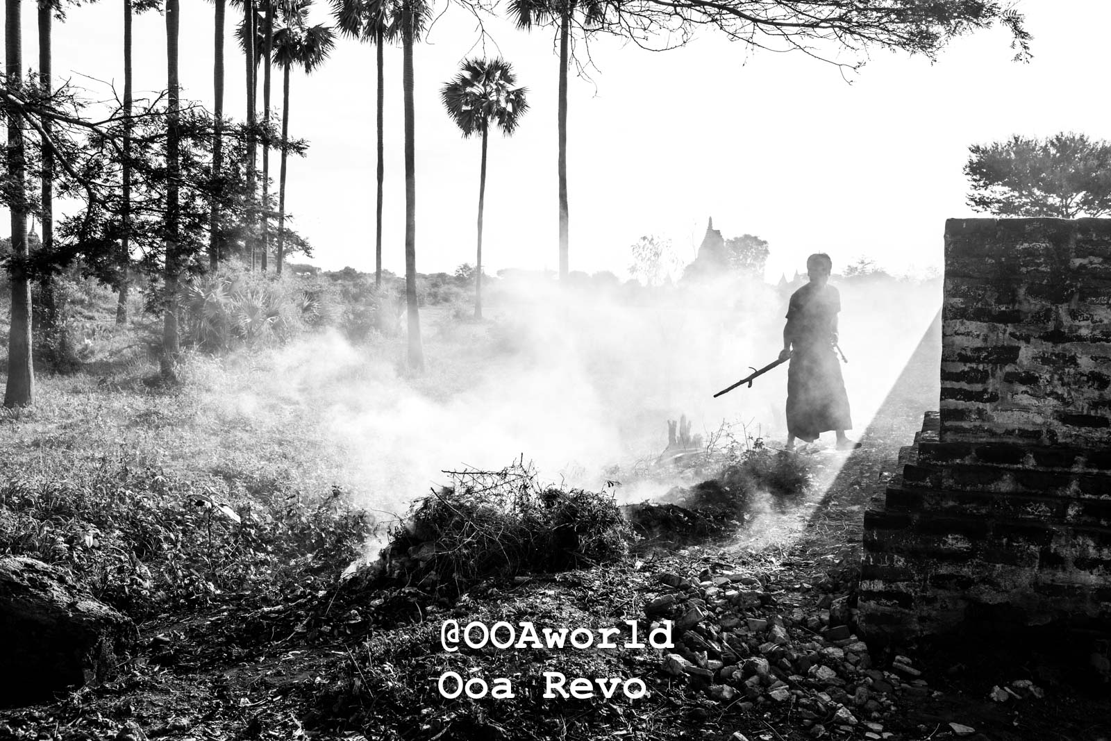 Bagan People Part I Bagan monk walking through smoke and palm trees Photo OOAworld
