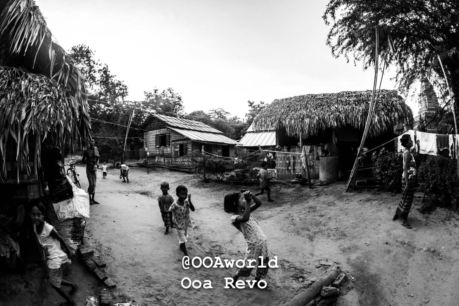 Bagan People Part II Bagan black and white village scene with children playing and thatched huts Photo OOAworld