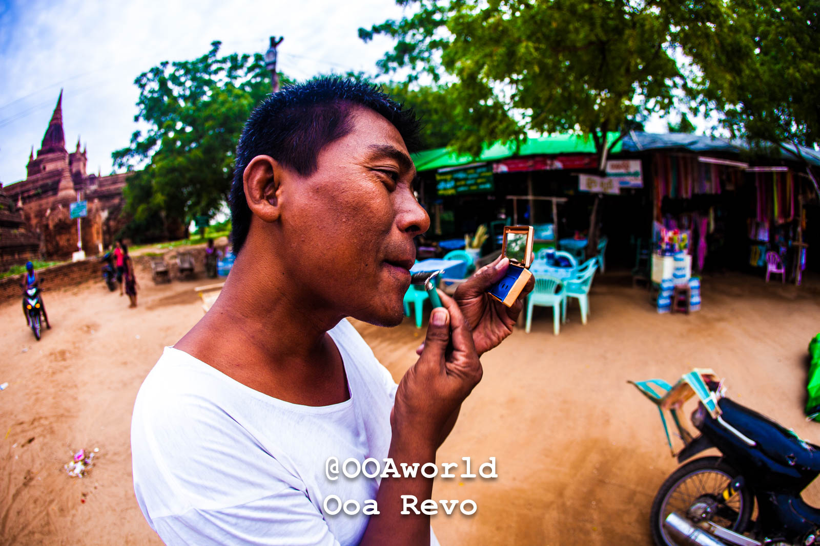 Bagan People Part II Bagan man using pocket mirror in street Photo OOAworld