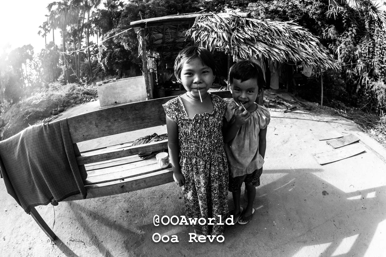 Bagan Portraits Bagan Two children smiling in front of a rural hut in black and white Photo OOAworld