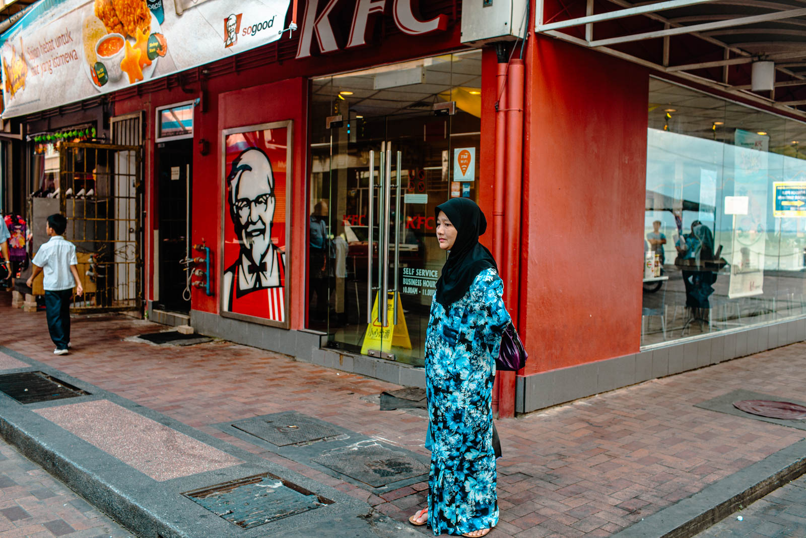Sendankan Borneo Woman in hijab outside KFC restaurant Photo OOAworld