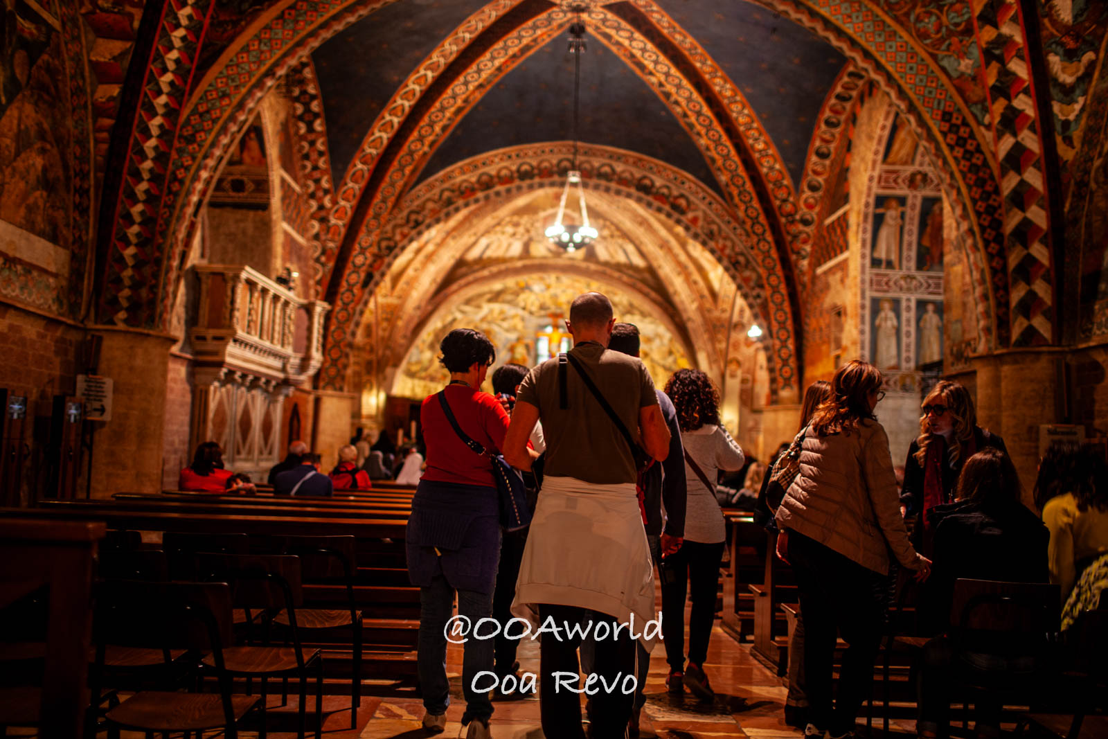 Assissi Italy tourists in ornate cathedral interior Photo OOAworld