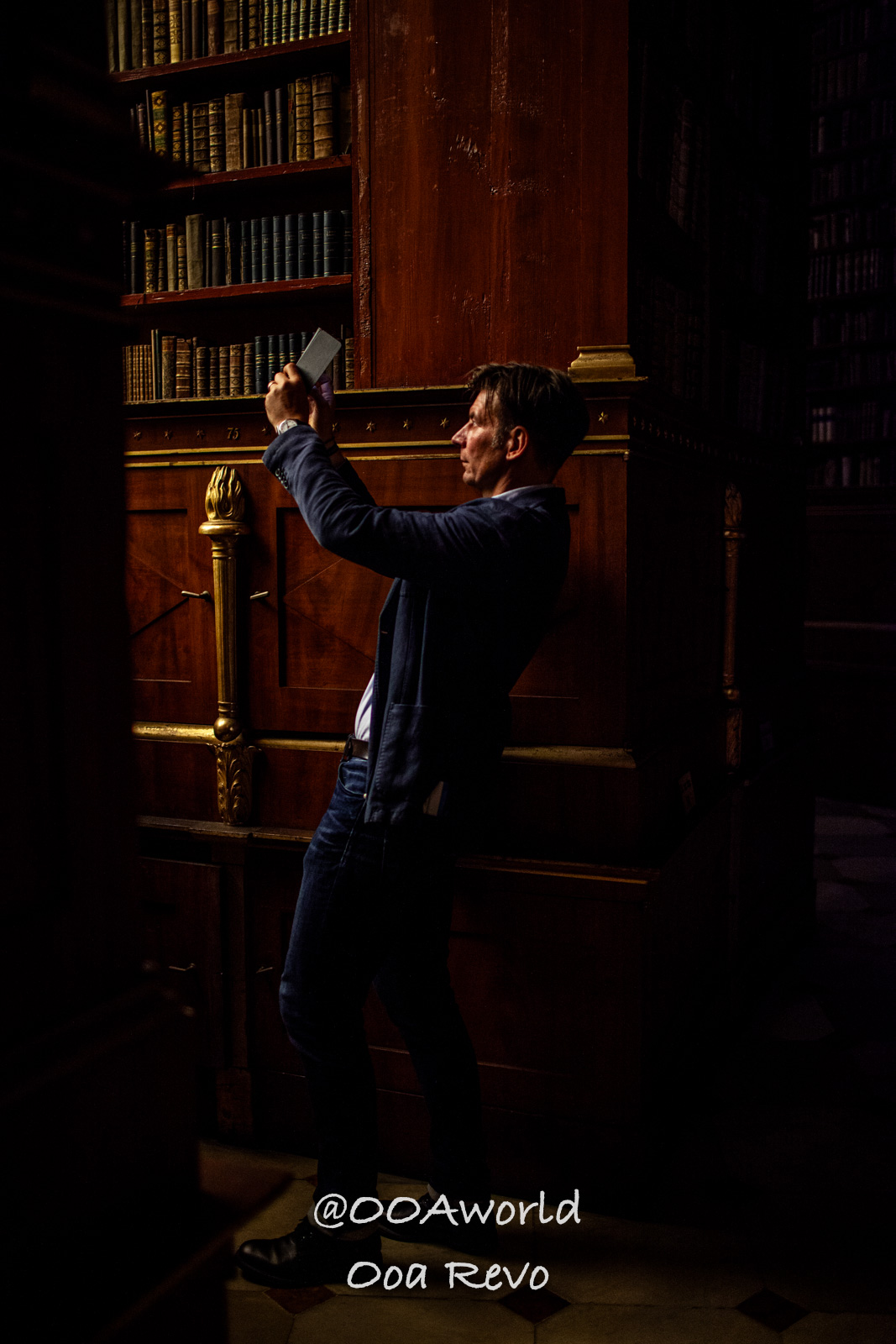 Vienna Austria man taking photo in historic library Photo OOAworld