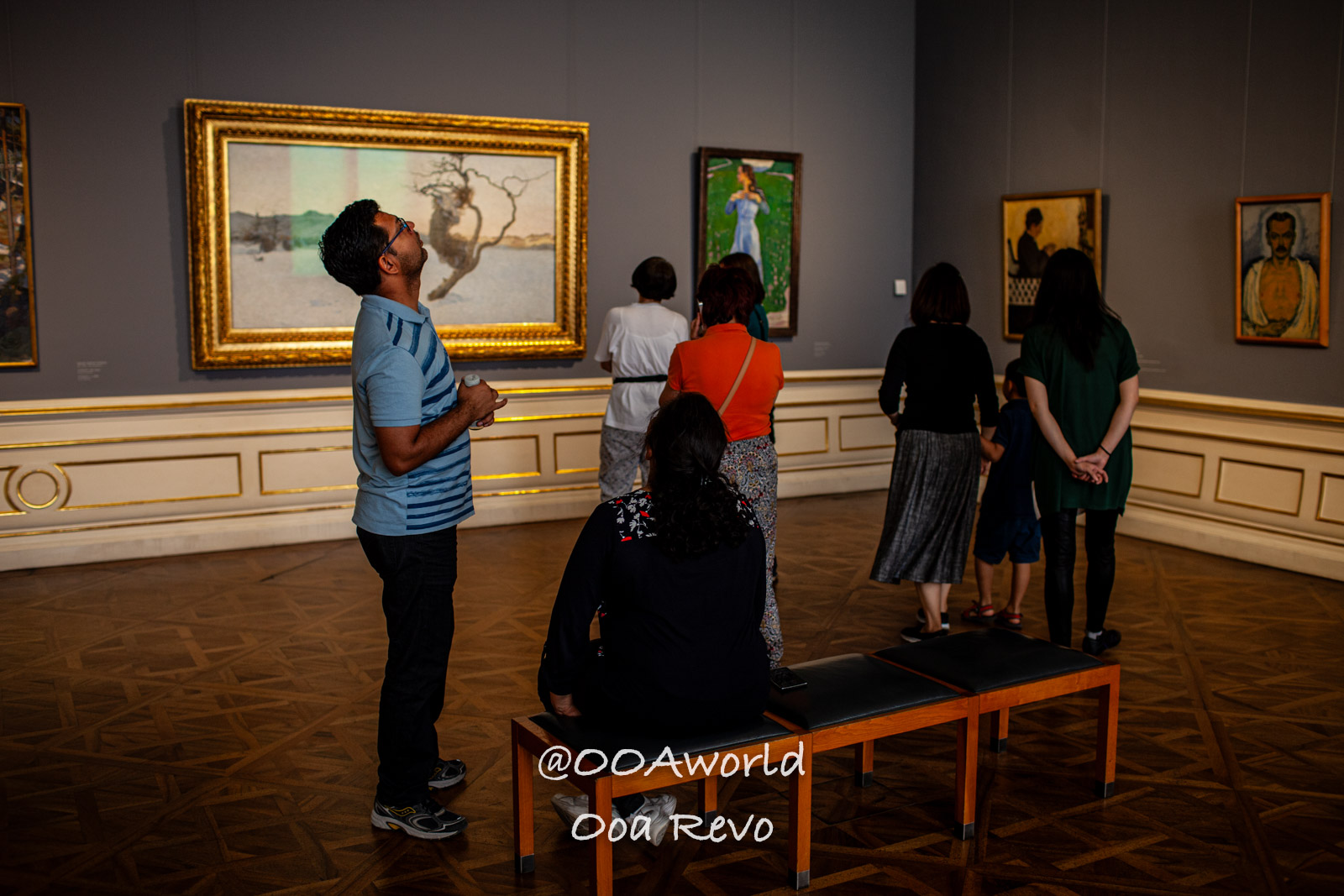 Vienna Austria art gallery visitors observing paintings Photo OOAworld