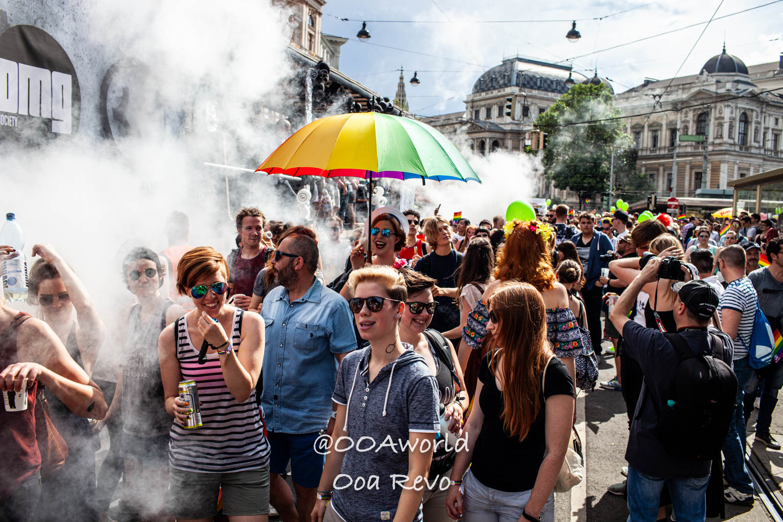 Vienna Gay Pride Austria Vibrant crowd celebrating outdoors with colorful umbrella and smoke Photo OOAworld