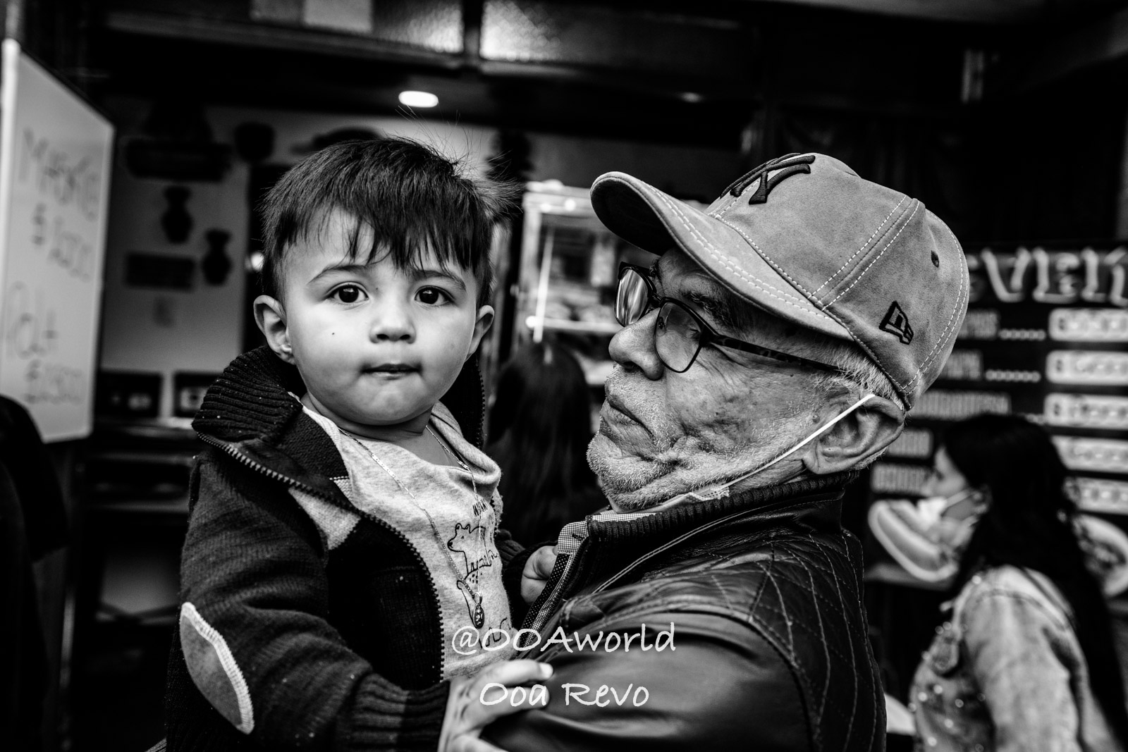 La Candelaria Bogota grandfather holding young child black and white Photo OOAworld