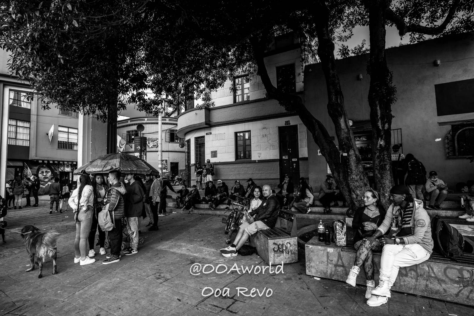 La Candelaria Bogota black and white urban street scene with people sitting and standing Photo OOAworld