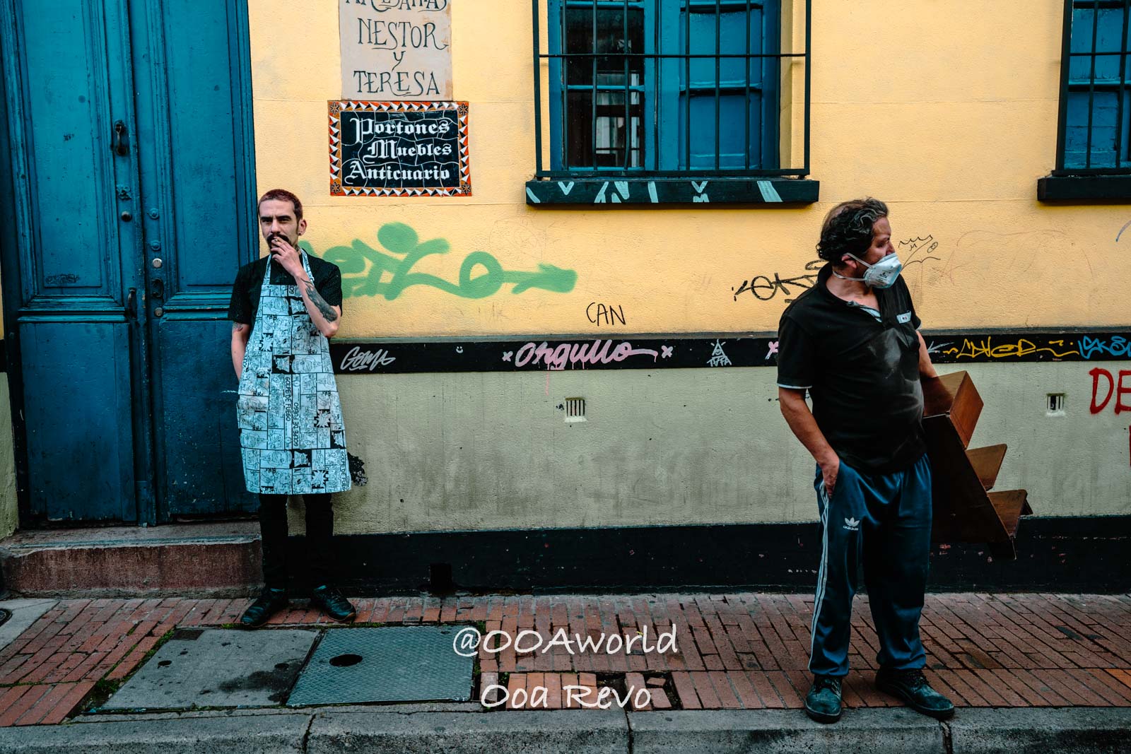 La Candelaria Bogota urban street scene with two men standing outside a building in Buenos Aires Photo OOAworld
