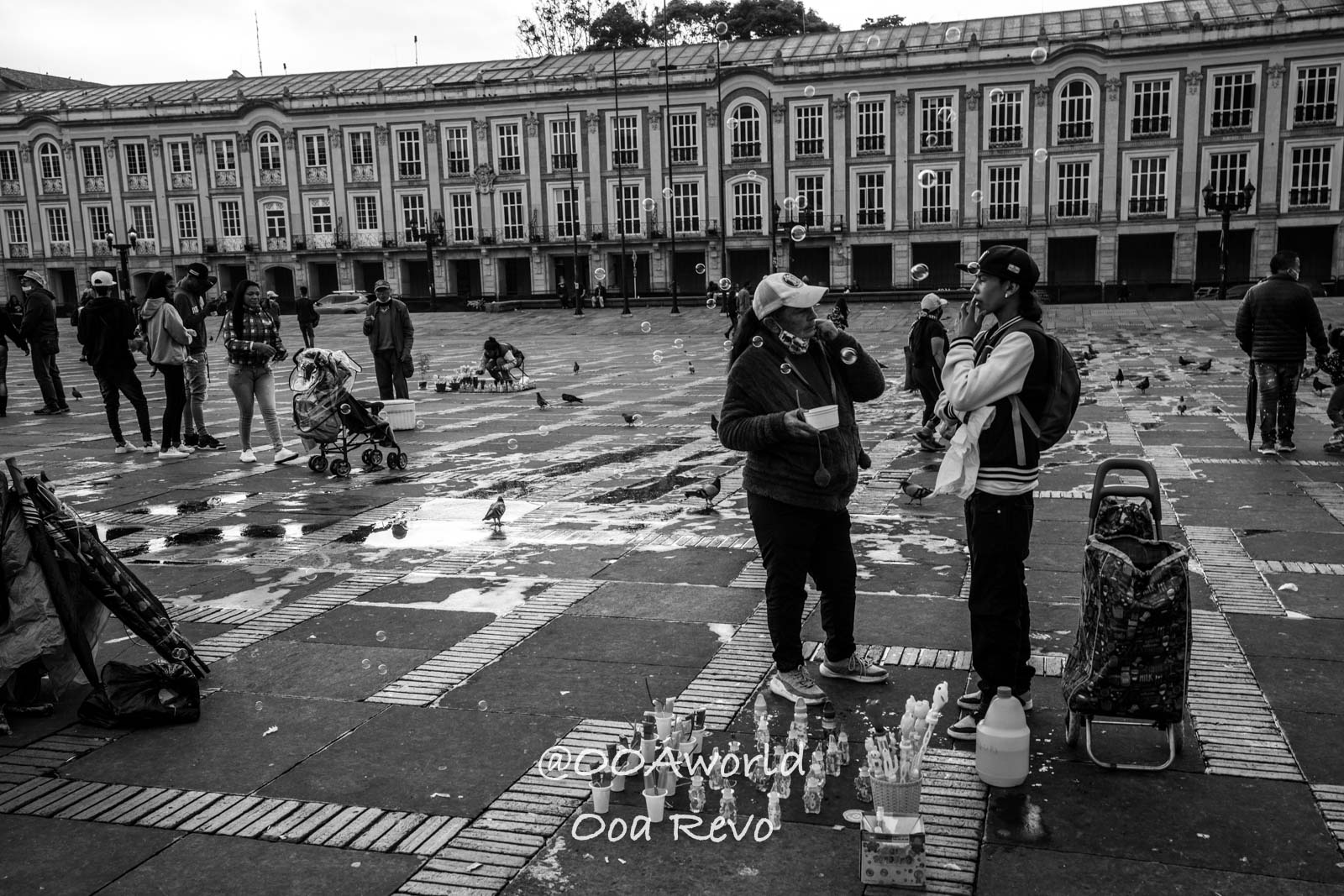 La Candelaria Bogota street vendors and people in public square black and white Photo OOAworld