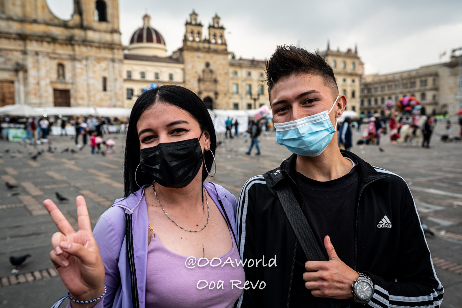 La Candelaria Bogota young people with masks in city square Photo OOAworld