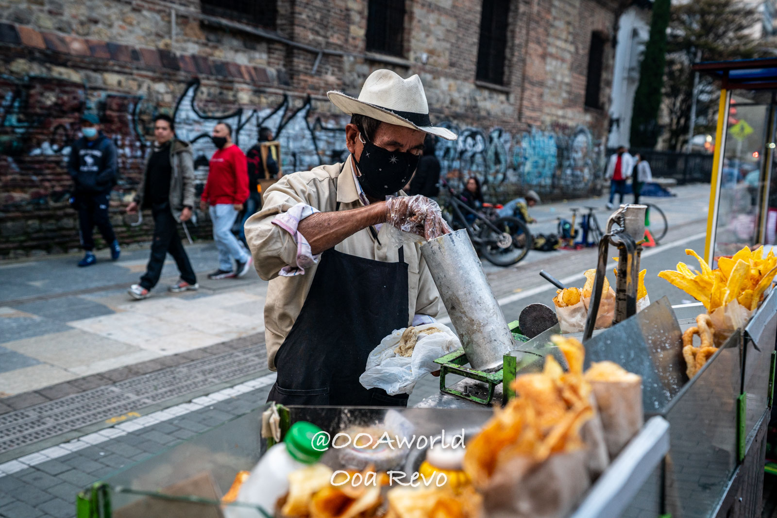 La Candelaria Bogota Street vendor preparing snacks in urban setting Photo OOAworld