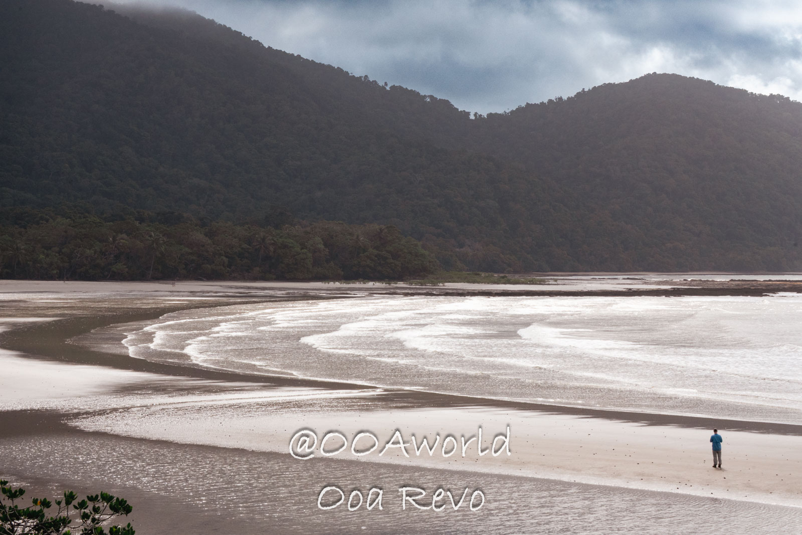 Daintree Forest Nature Landscapes Australia remote beach with forested hills and person walking Photo OOAworld