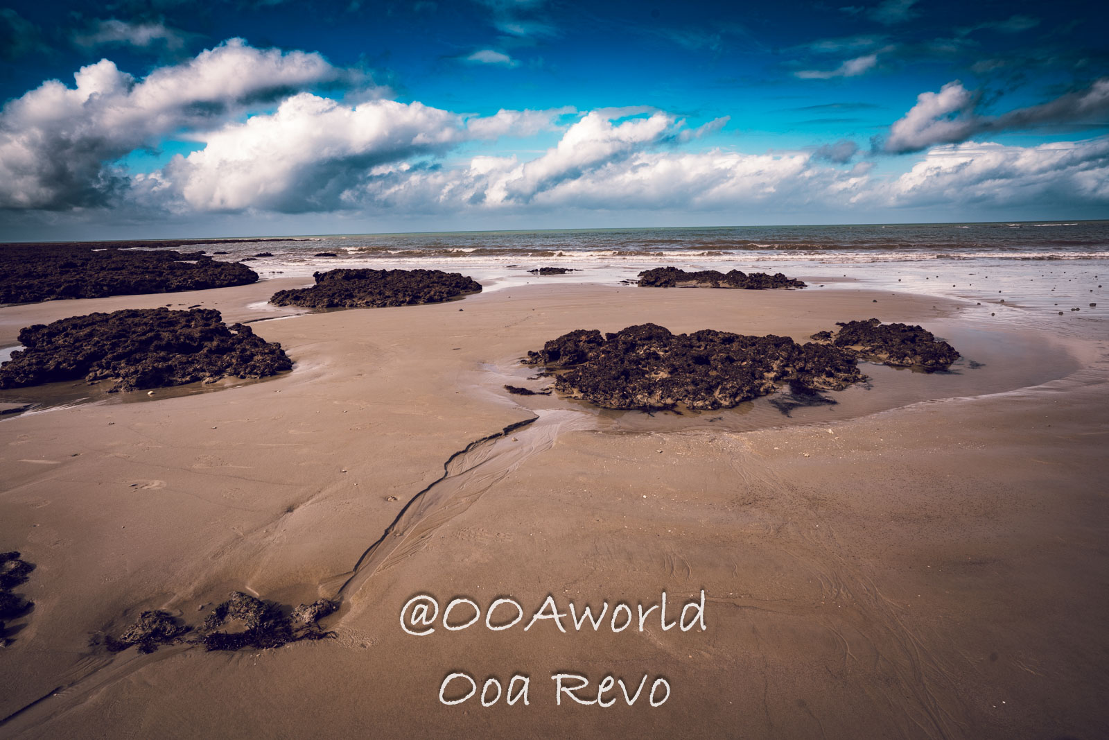 Daintree Forest Nature Landscapes Australia Sandy beach with rocks under blue sky Photo OOAworld