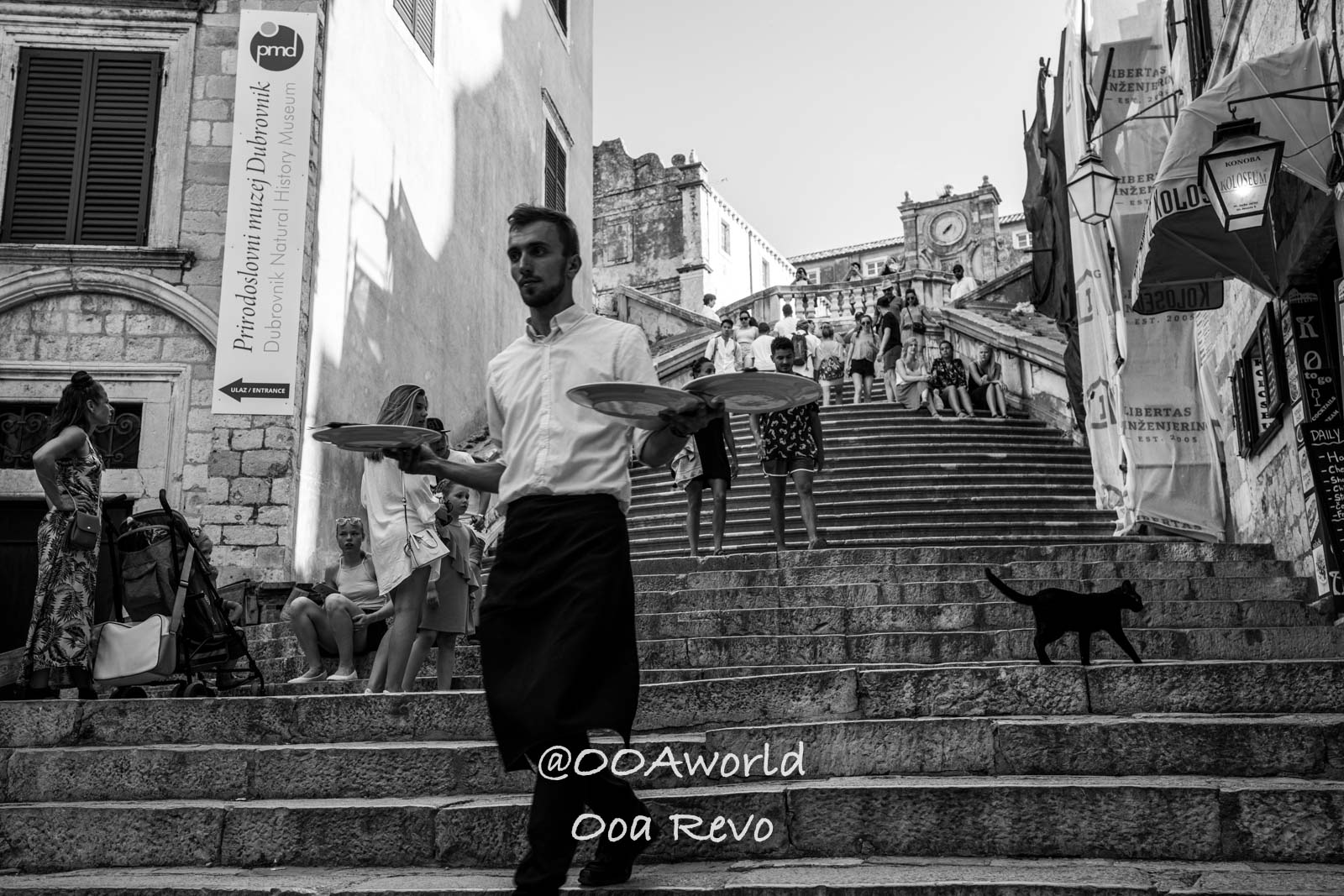 Dubrovnik Croatia Black and white Dubrovnik street scene with waiter on stairs Photo OOAworld