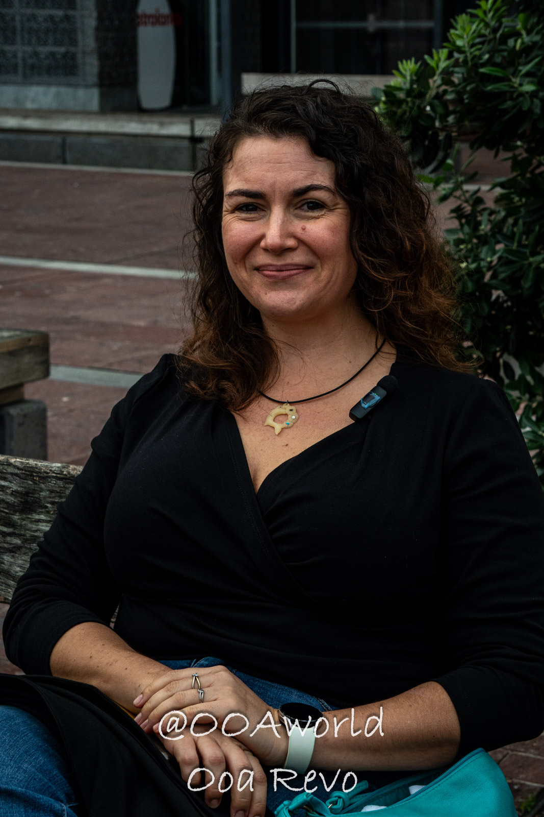 Hobbiton, Coromandel, Auckland New Zealand smiling woman sitting on a bench Photo OOAworld