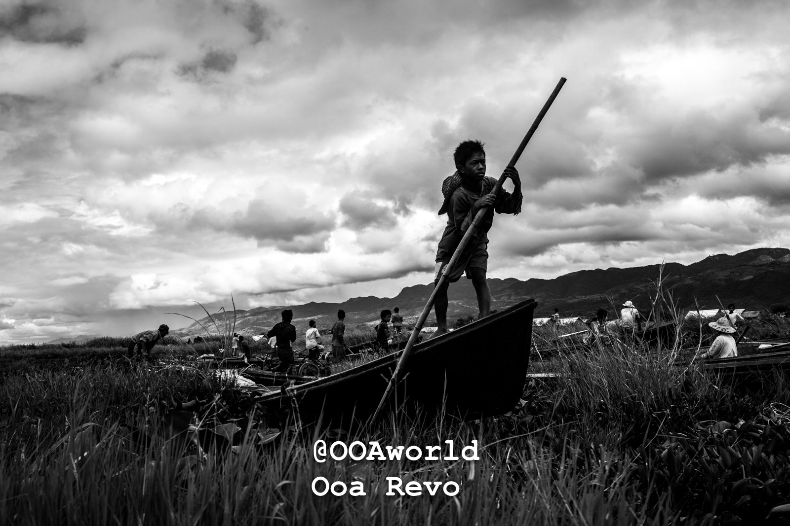 Inle Lake People Inle Lake young boy paddling boat in rural landscape Photo OOAworld
