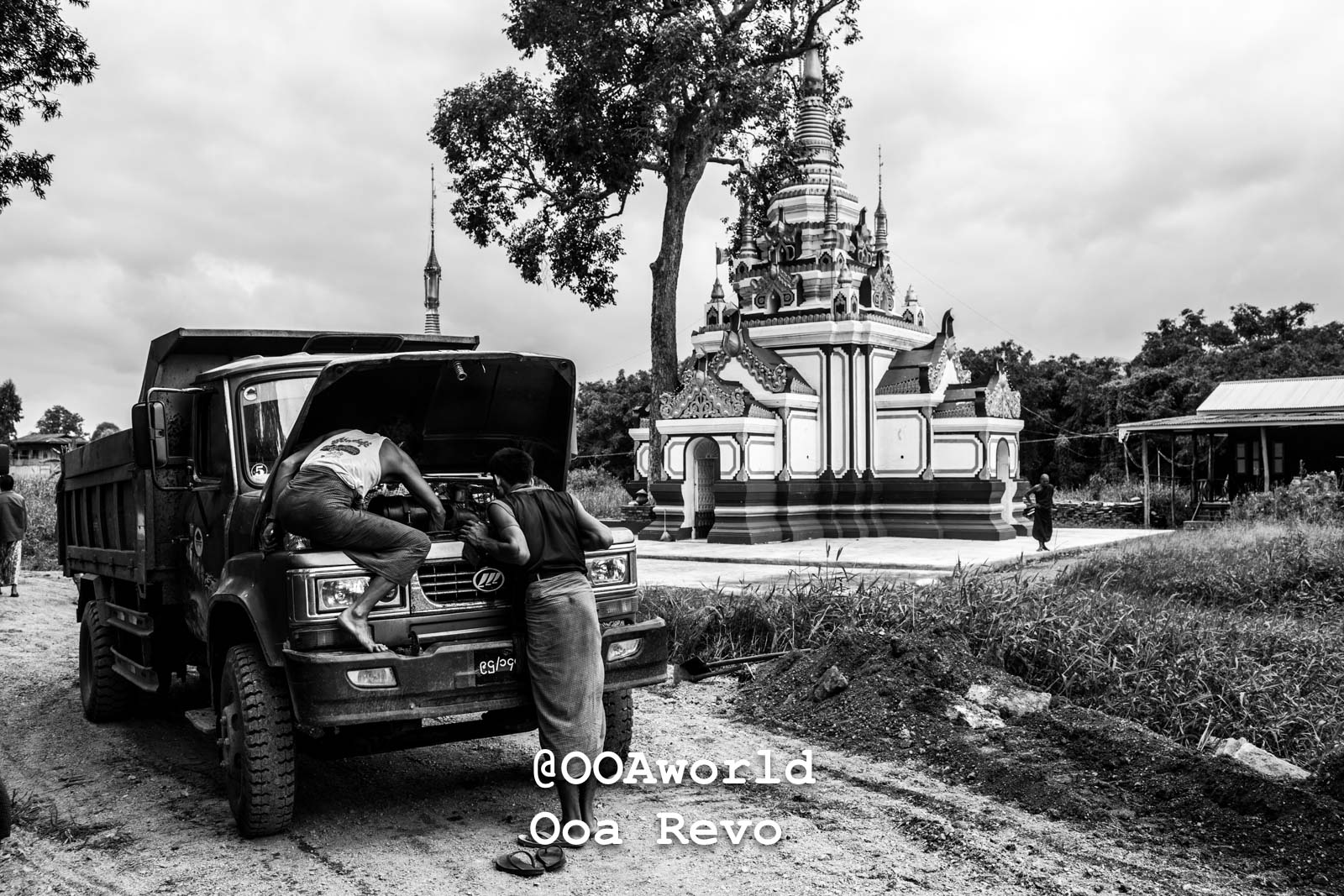 Inle Lake People Inle Lake men repairing truck near temple black and white Photo OOAworld