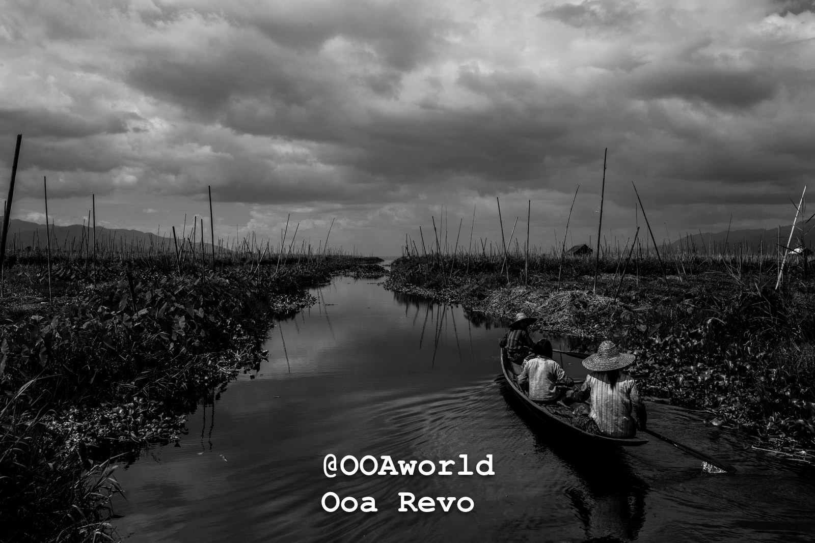 black and white image of people in a boat on a canal inle lake myanmar Photo OOAworld