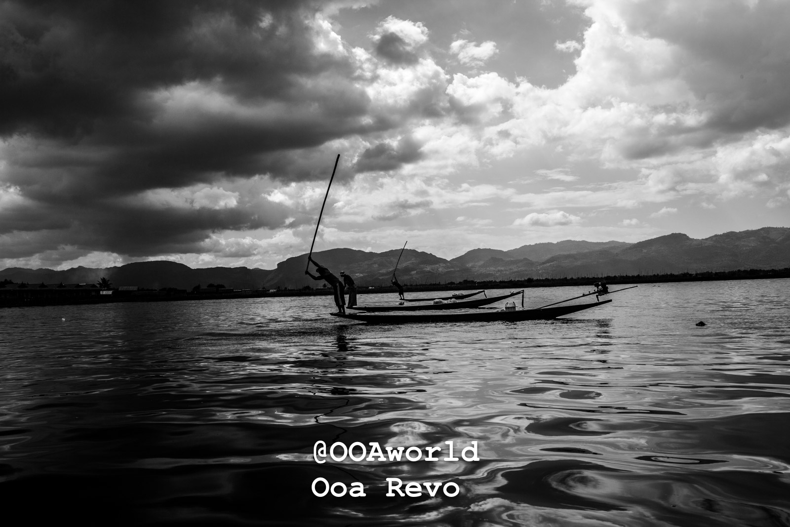 fishermen on boats on Inle Lake under cloudy sky black and white Photo OOAworld