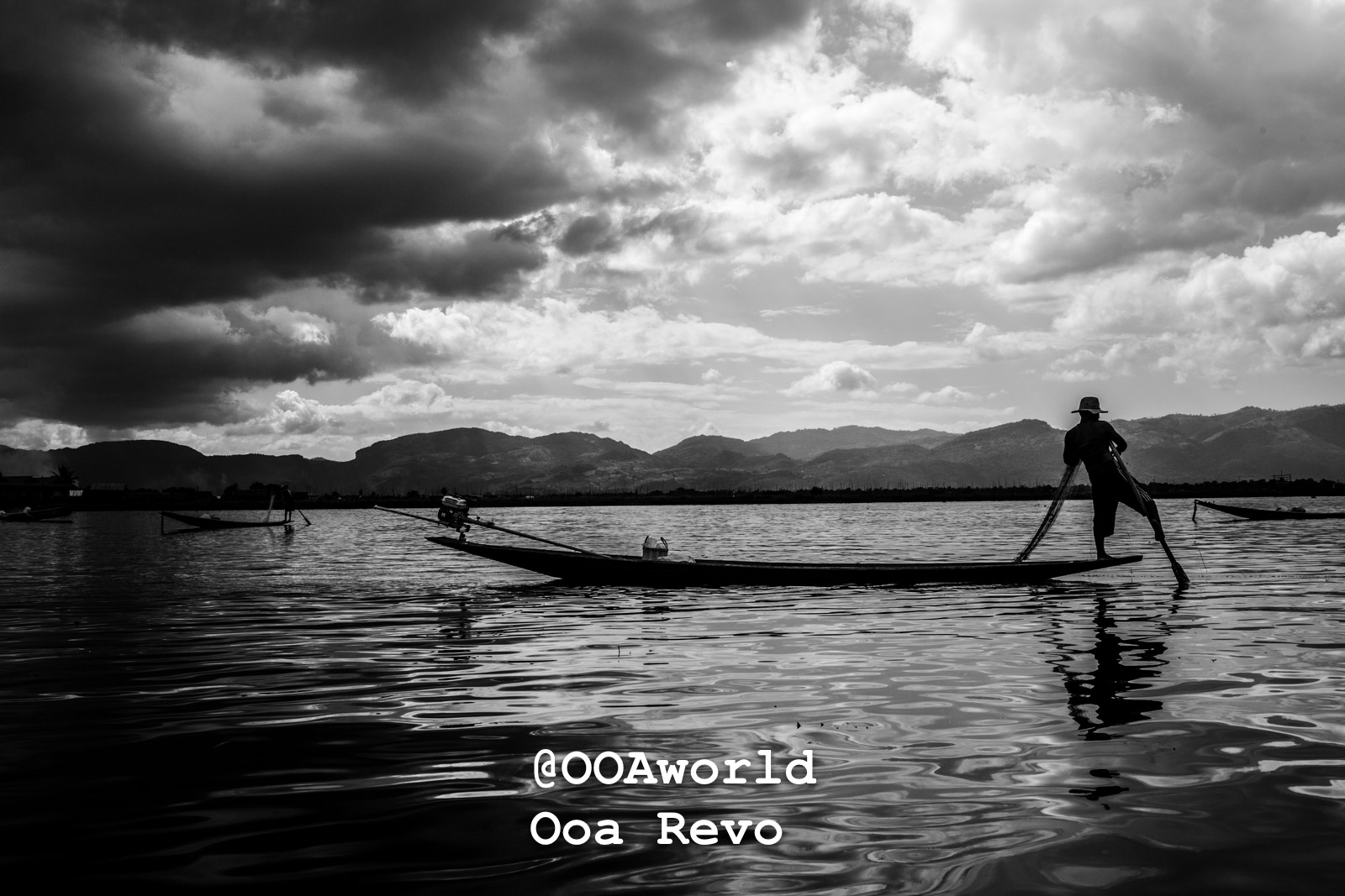 Inle Lake People and Landscape Inle Lake Fisherman on boat under cloudy sky black and white Photo OOAworld