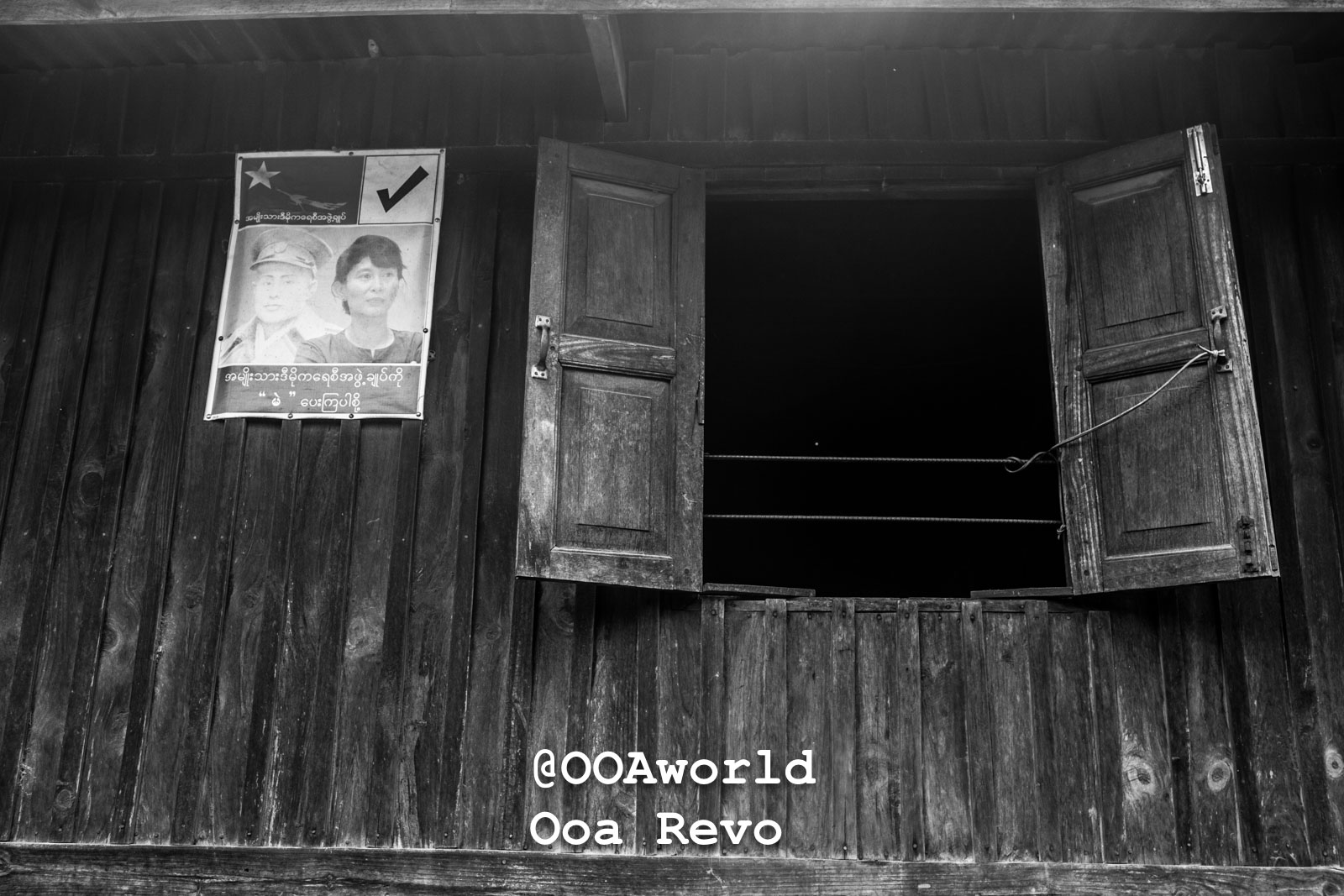 Kalaw Landscapes and Textures Kalaw Htee Thein Black and white photo of a wooden building with an open window and political poster Photo OOAworld