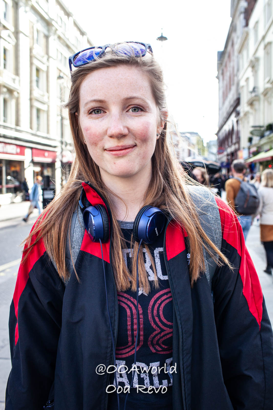 London People and Streets London woman in red and black jacket with headphones street photo Photo OOAworld