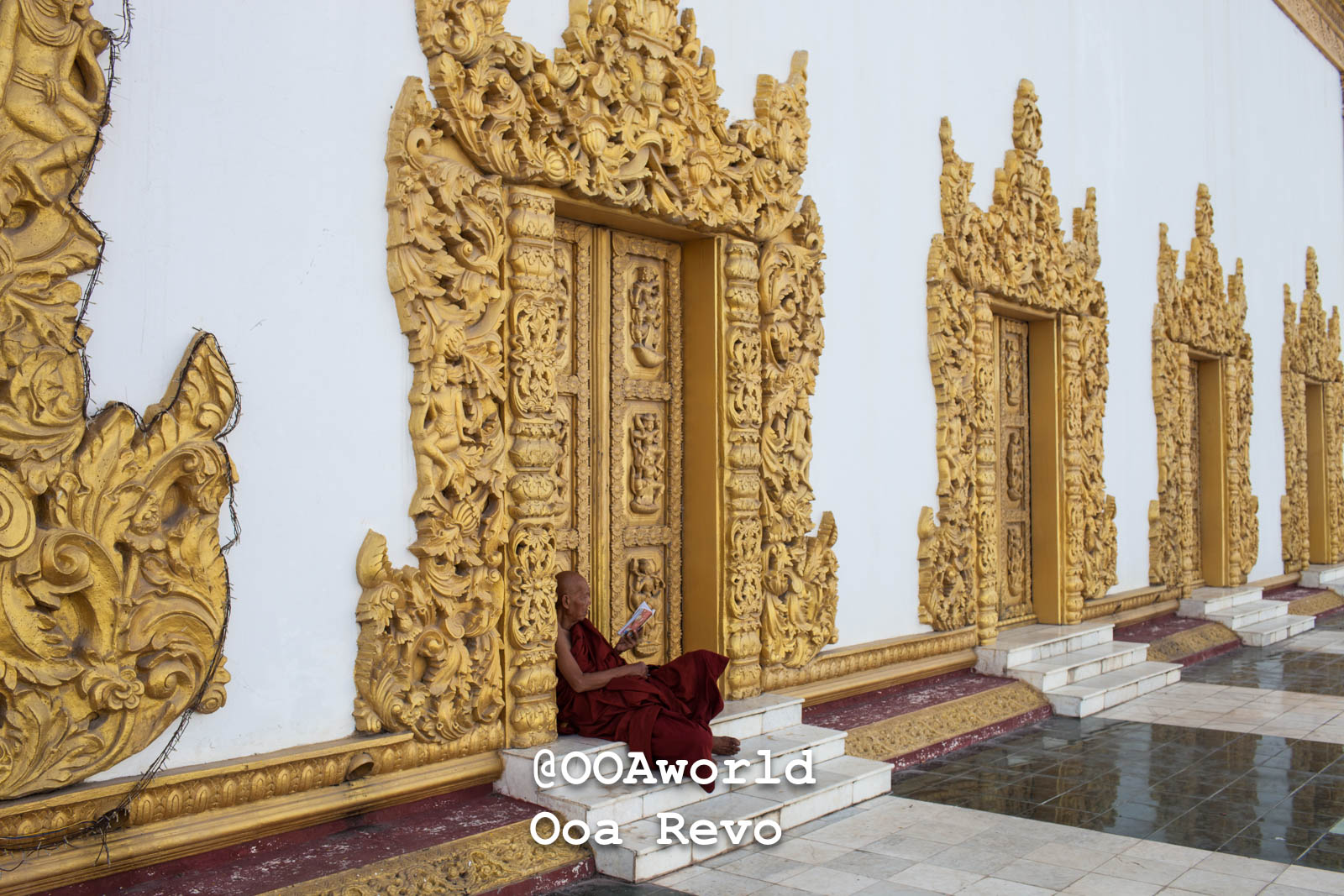 Mandalay Landscapes and Textures Mandalay monk reading near ornate golden temple doors Photo OOAworld