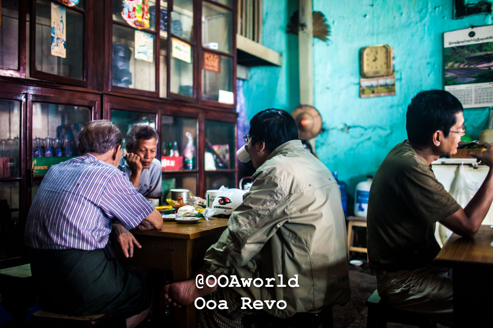 men conversing in traditional cafe Myanmar Photo OOAworld