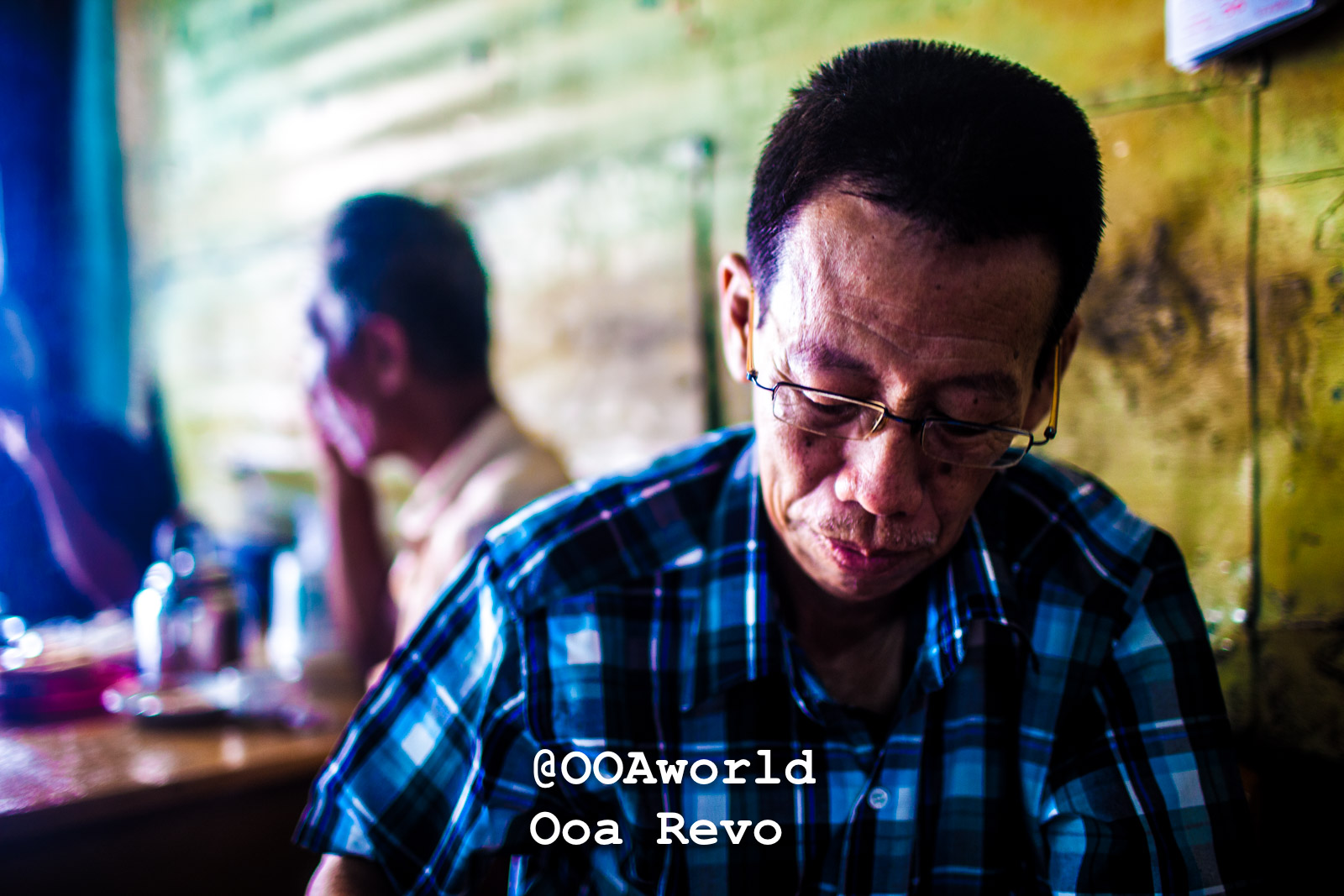Mawlamyine Myanmar Man in a blue plaid shirt sitting in a cafe Photo OOAworld