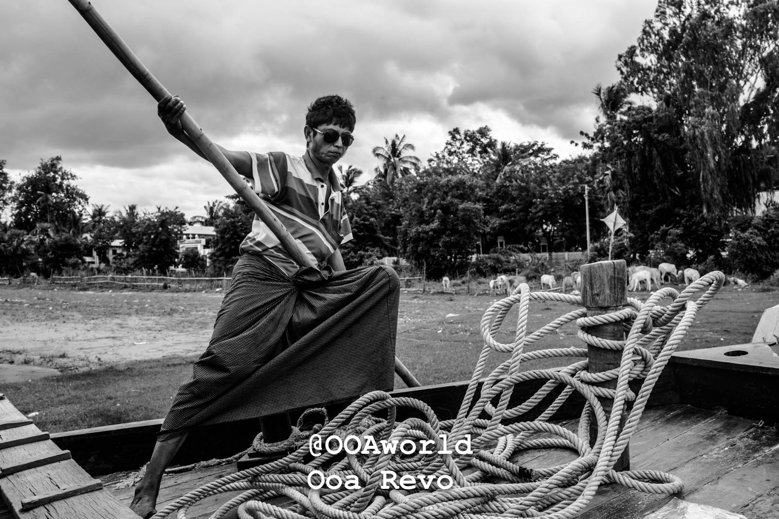 Mingun Myanmar man rowing boat with ropes black and white Photo OOAworld