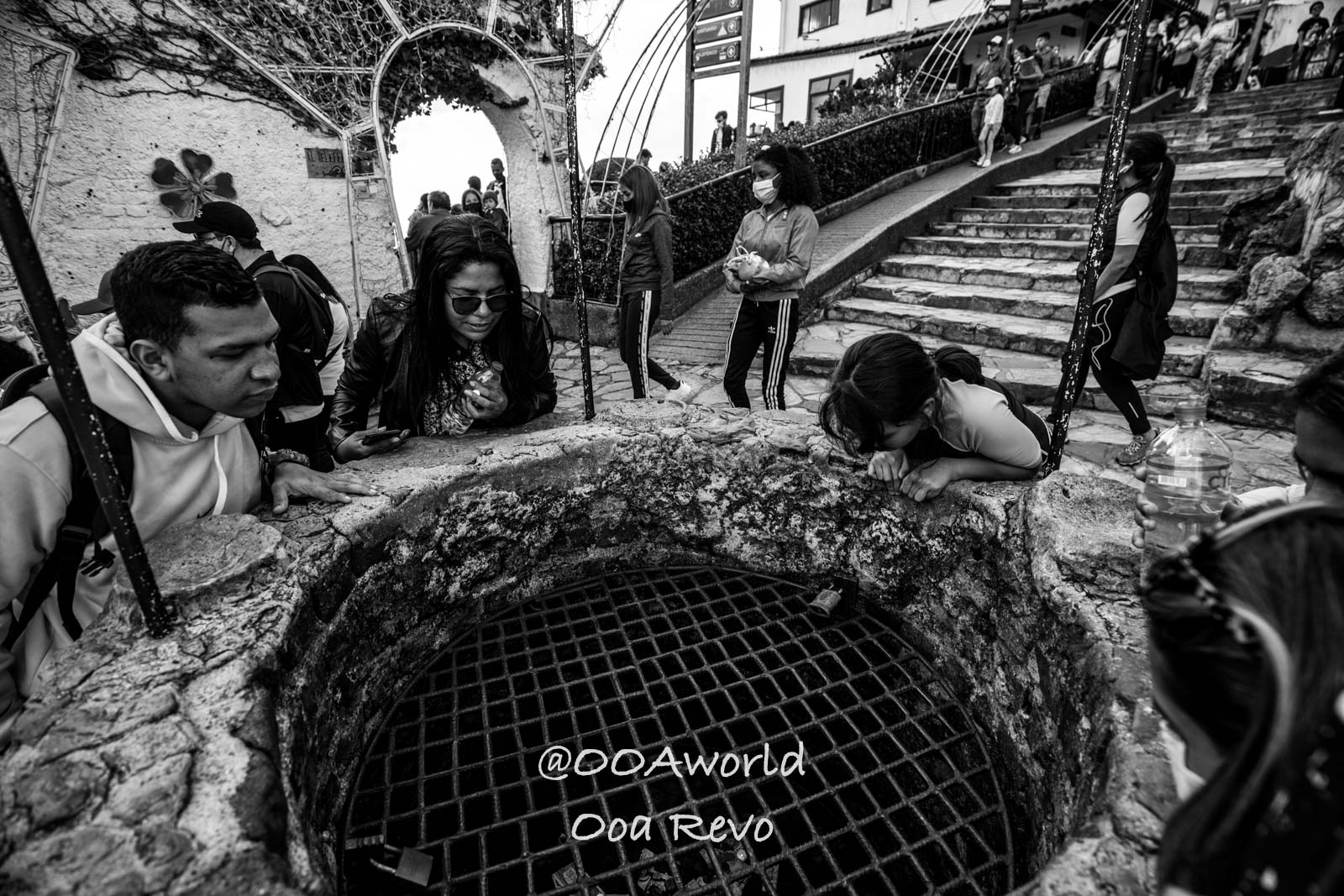 Monserrate Sanctuary Bogota tourists exploring well along cobblestone path Black and White Photo OOAworld Monserrate Sanctuary Bogota tourists exploring well along cobblestone path Black and White Photo OOAworld