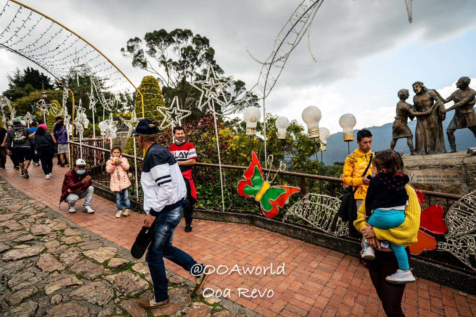 Monserrate Sanctuary Bogota tourists at scenic overlook with festive decorations Photo OOAworld Monserrate Sanctuary Bogota tourists at scenic overlook with festive decorations Photo OOAworld