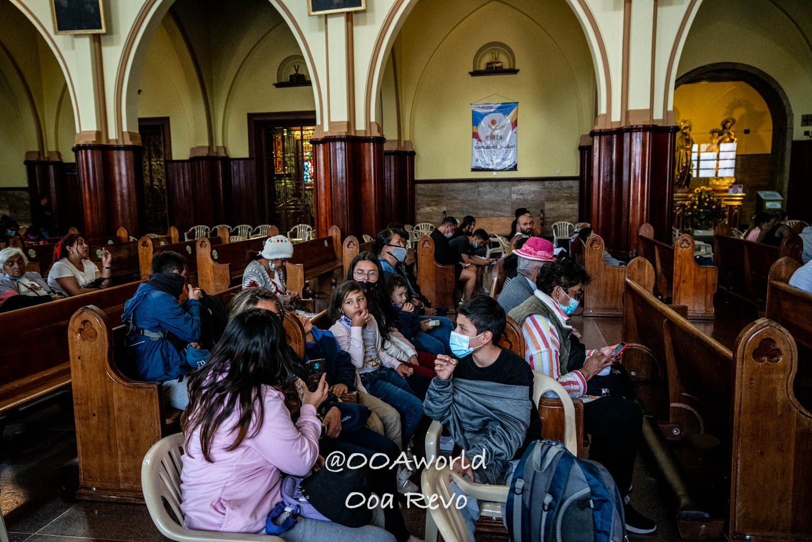 Monserrate Sanctuary Bogota church interior with community gathering Photo OOAworld Monserrate Sanctuary Bogota people sitting in church pews Photo OOAworld