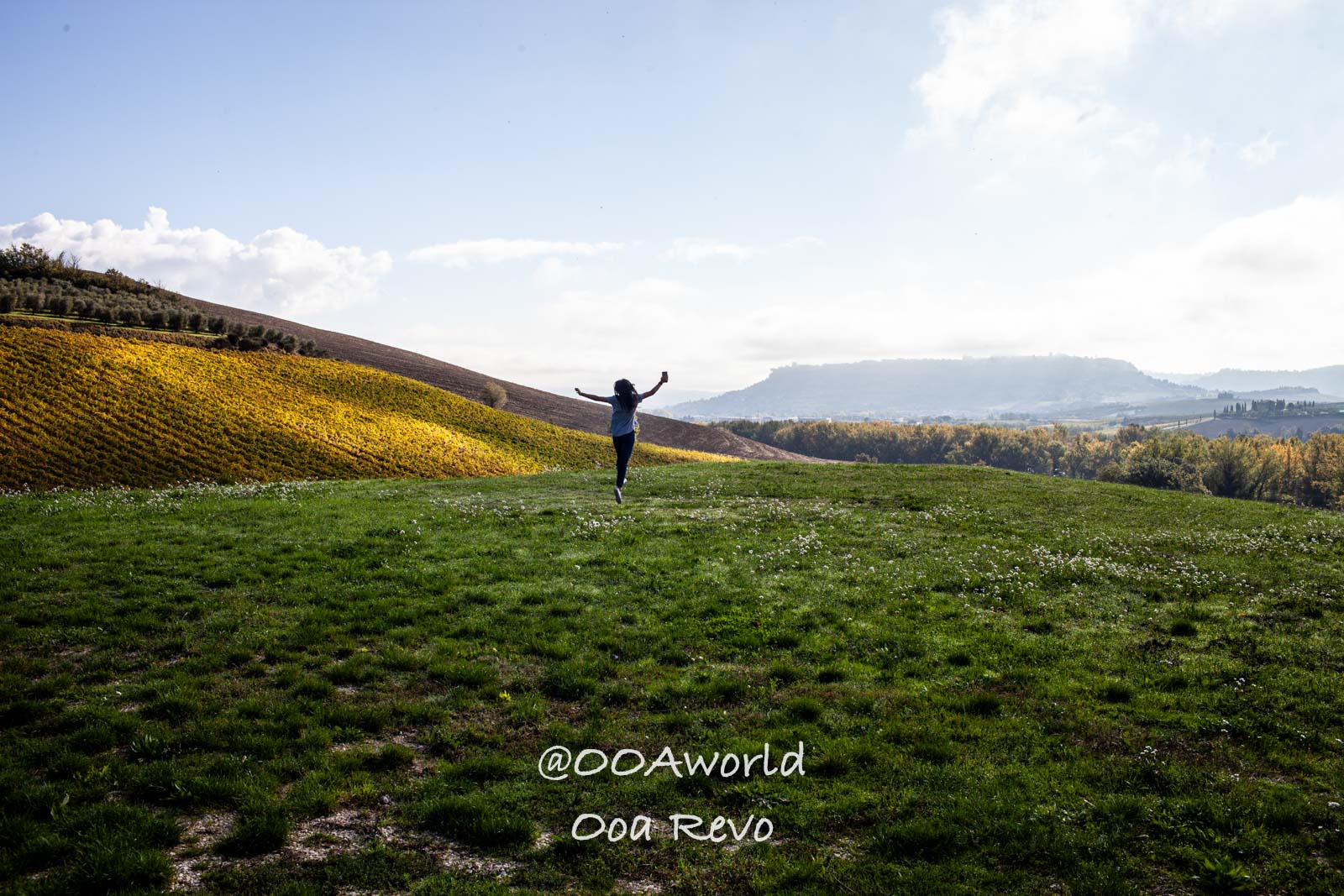 Orvieto Italy person running in green field with hills and sky Photo OOAworld