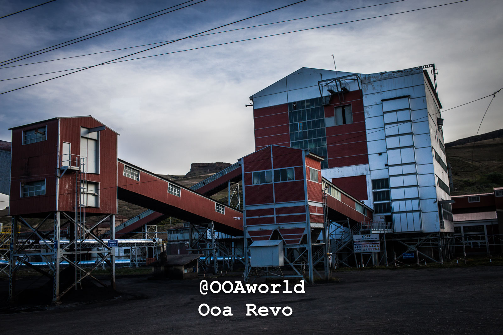 Puerto Natales Post Trek Torres Del Paine Trek industrial building with conveyor belts under cloudy sky Photo OOAworld
