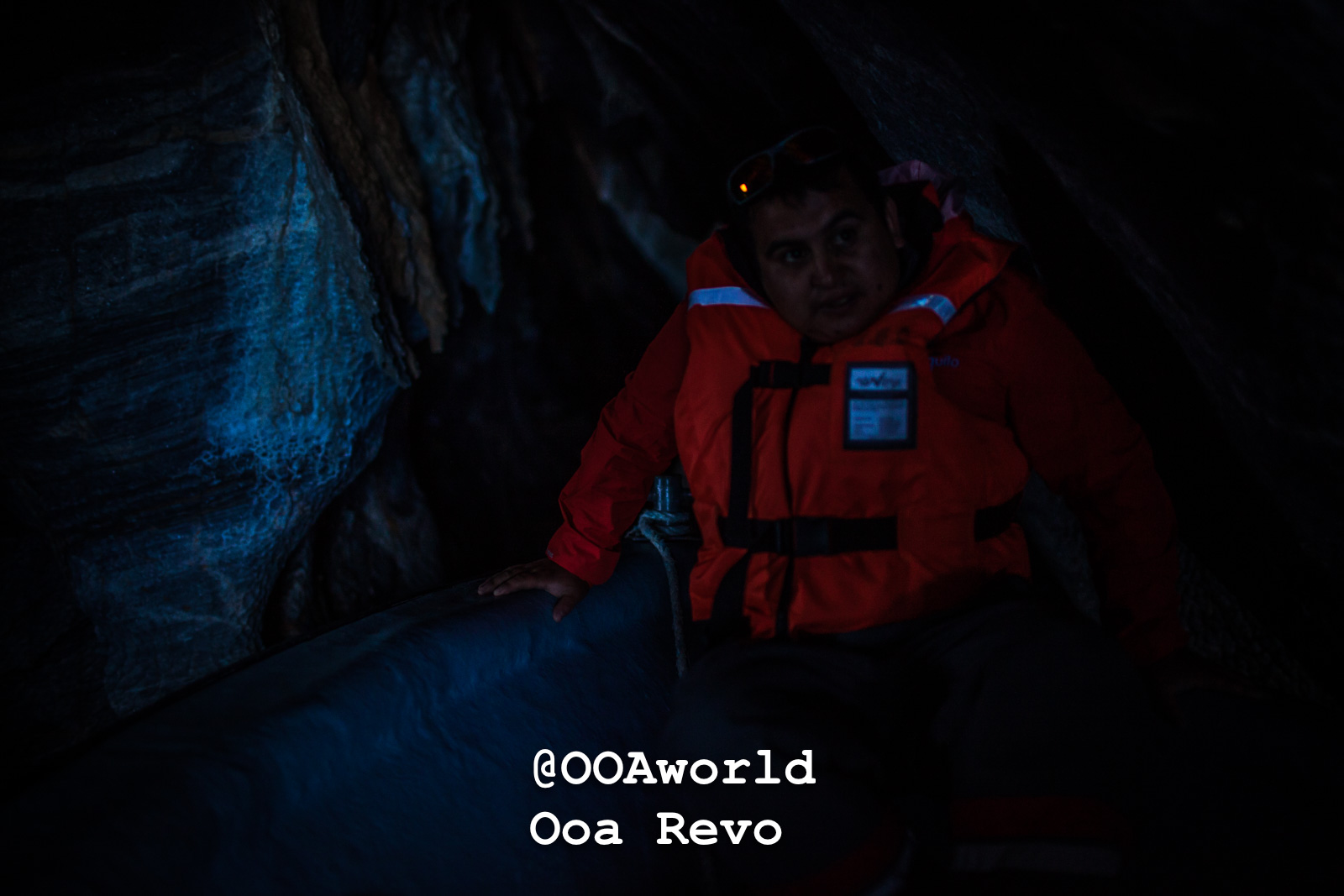Puerto Rio Tranquilo People and Landscapes Puerto Rio Tranquilo OOAworld man in orange life jacket exploring dark cave Photo OOAworld