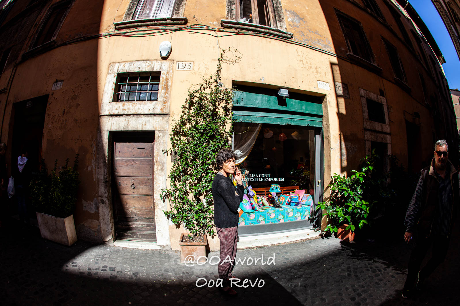 Rome street textile store woman Photo OOAworld woman outside textile shop in Rome street corner Photo OOAworld