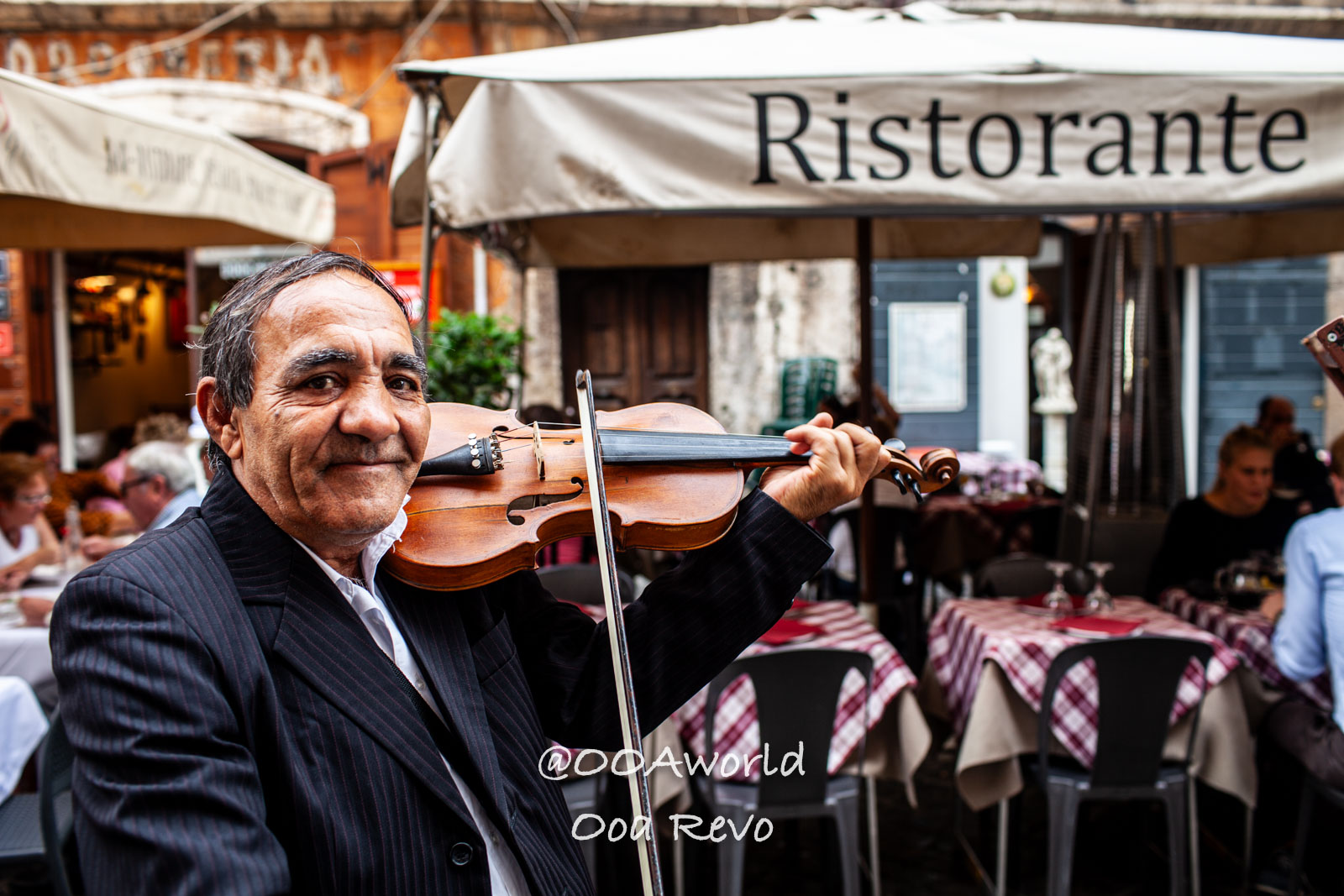 Rome Jewish Quarter Rome Italian street musician plays violin outside restaurant Photo OOAworld
