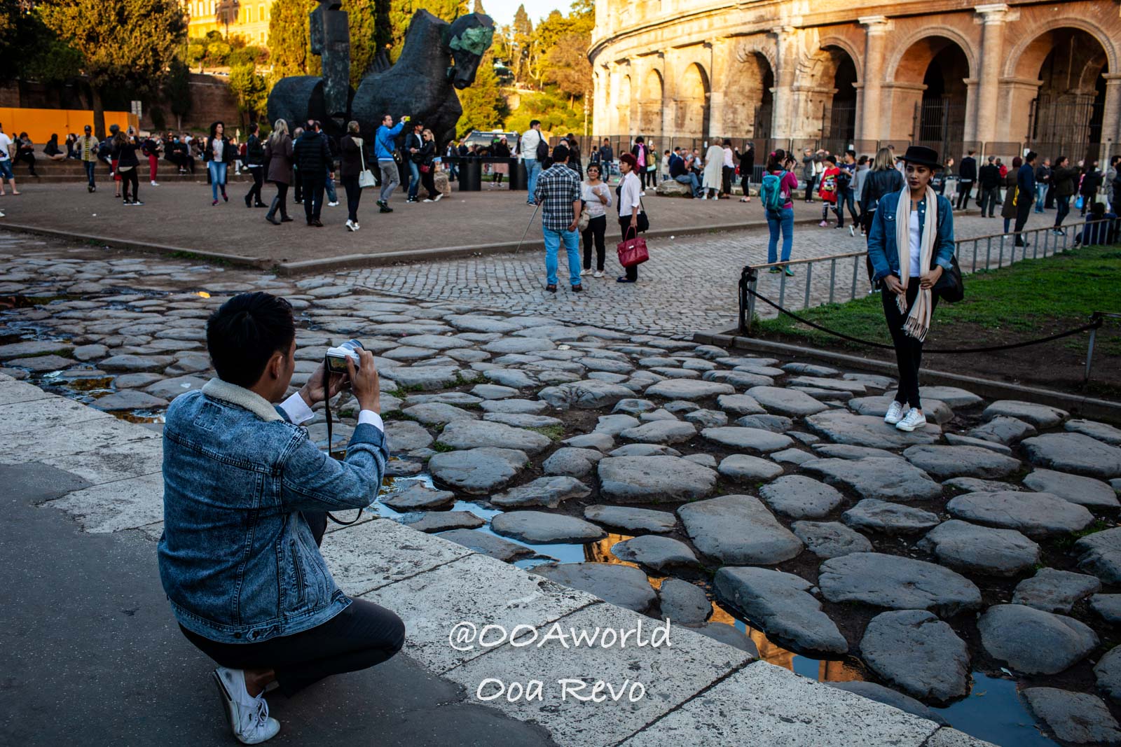 Tourists taking photos outside Colosseum Rome Photo OOAworld