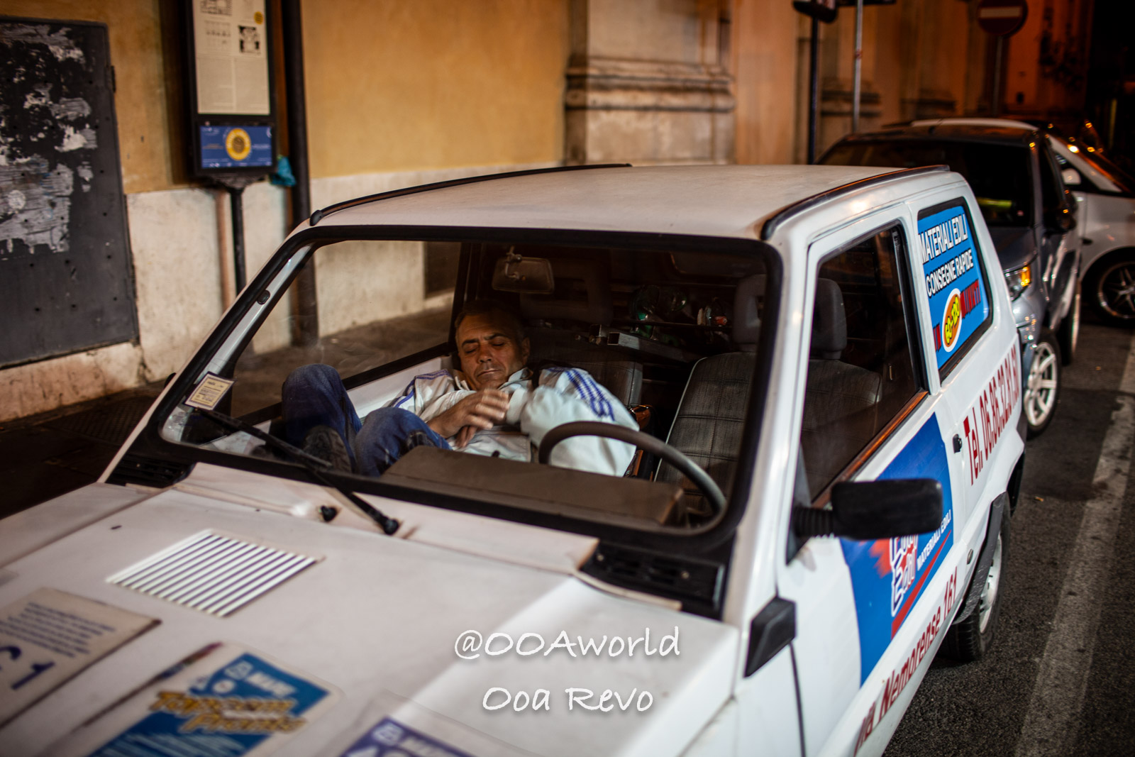 Rome Street Photography Rome man sleeping in parked car at night street Photo OOAworld