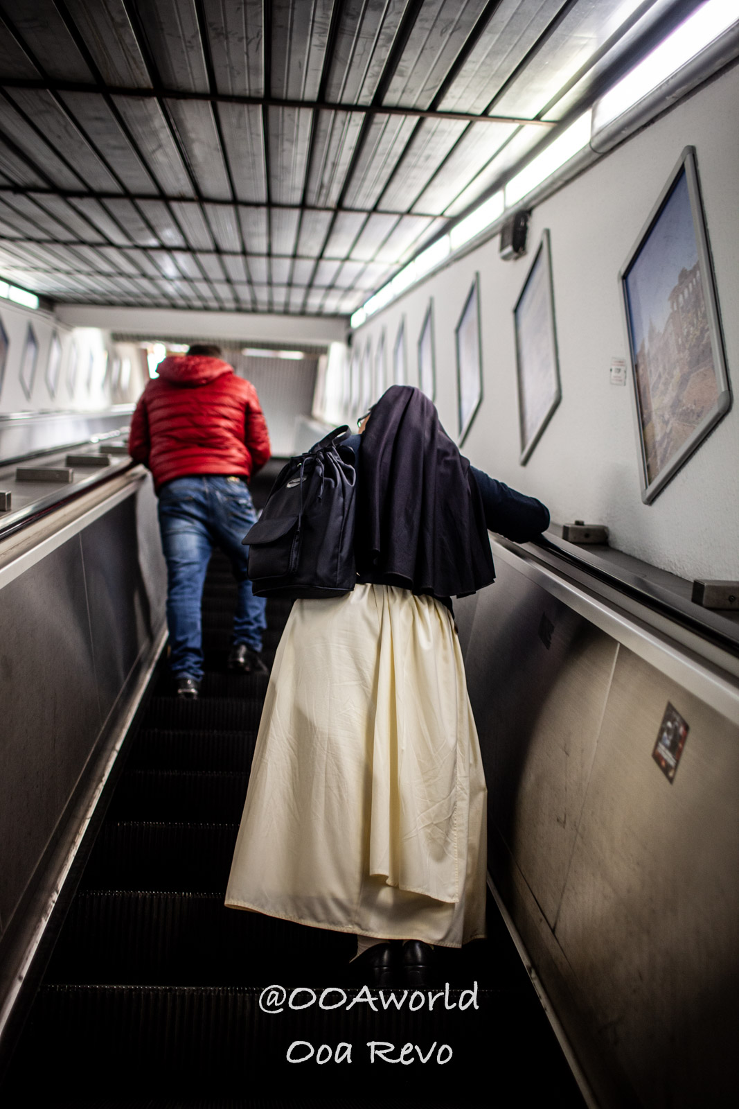 Rome Street Photography Rome nun on escalator in red jacket woman in city metro Photo OOAworld