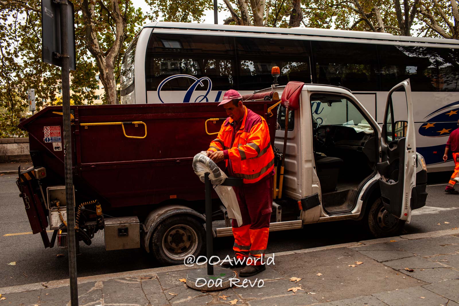 Rome Street Photography Rome Street worker in orange uniform loading truck Photo OOAworld