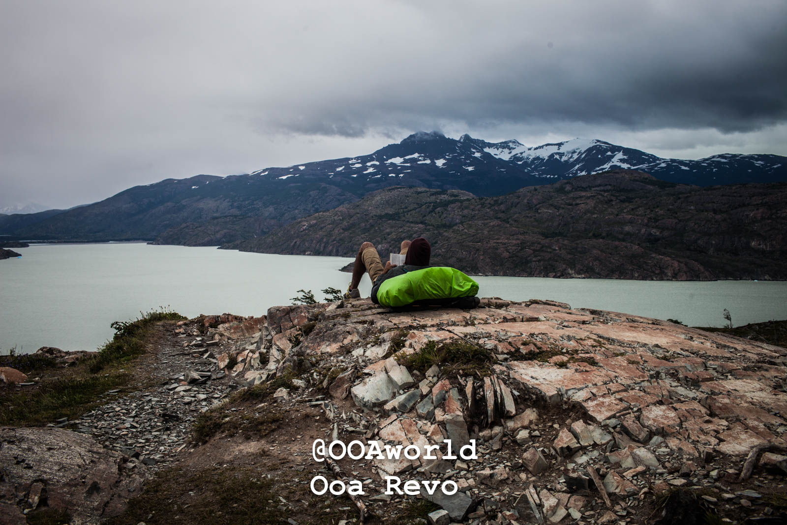 Torres Del Day Arrival Day Torres Del Paine Trek hiker resting overlooking Patagonian lake mountains Photo OOAworld