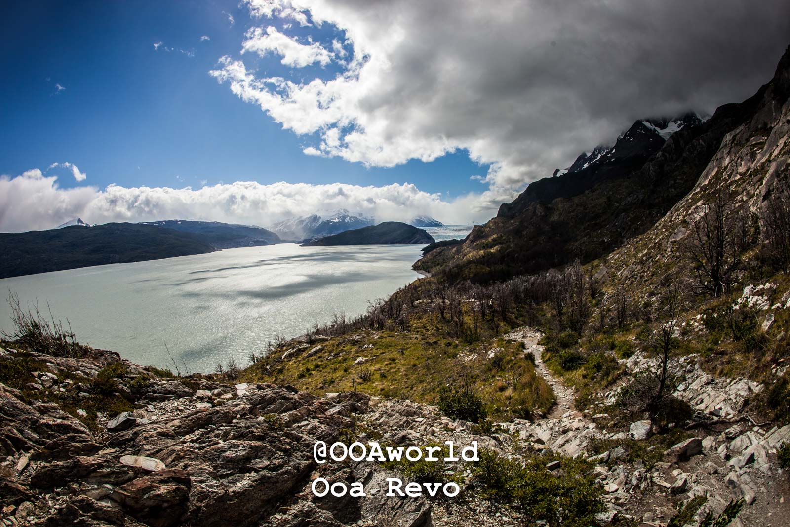 Torres Del Paine Day 1 Torres Del Paine Trek Dramatic cloudscape over pristine lake in mountainous landscape Photo OOAworld