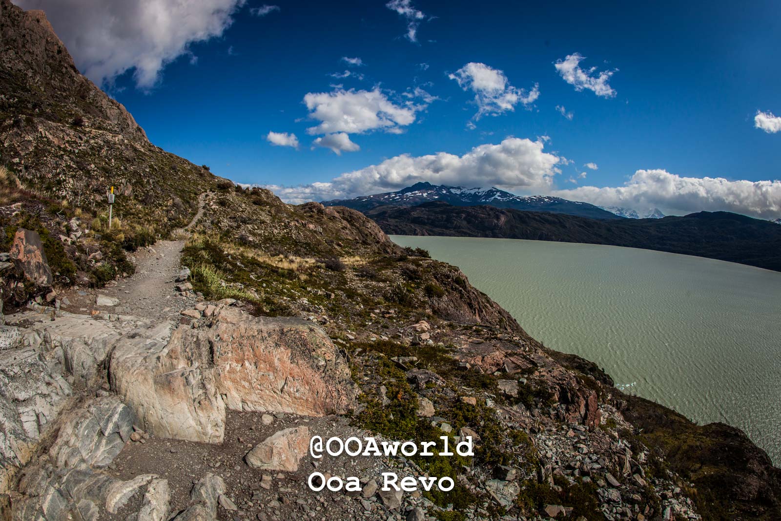 Torres Del Paine Day 1 Torres Del Paine Trek Mountain trail overlooking lake and snowcapped mountains Photo OOAworld