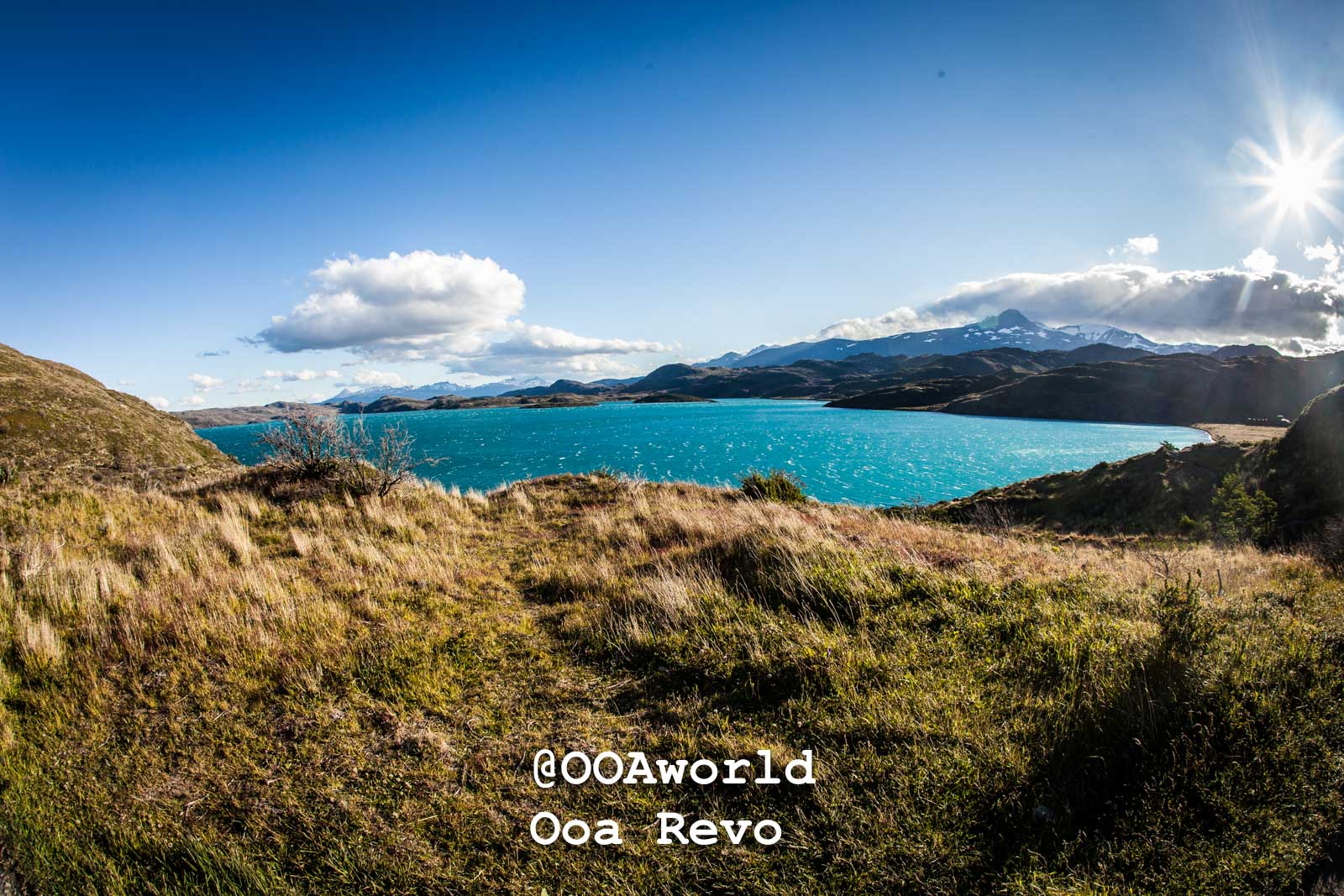 Torres Del Paine Day 1 Torres Del Paine Trek Scenic view of turquoise lake and grassy landscape with mountains Photo OOAworld