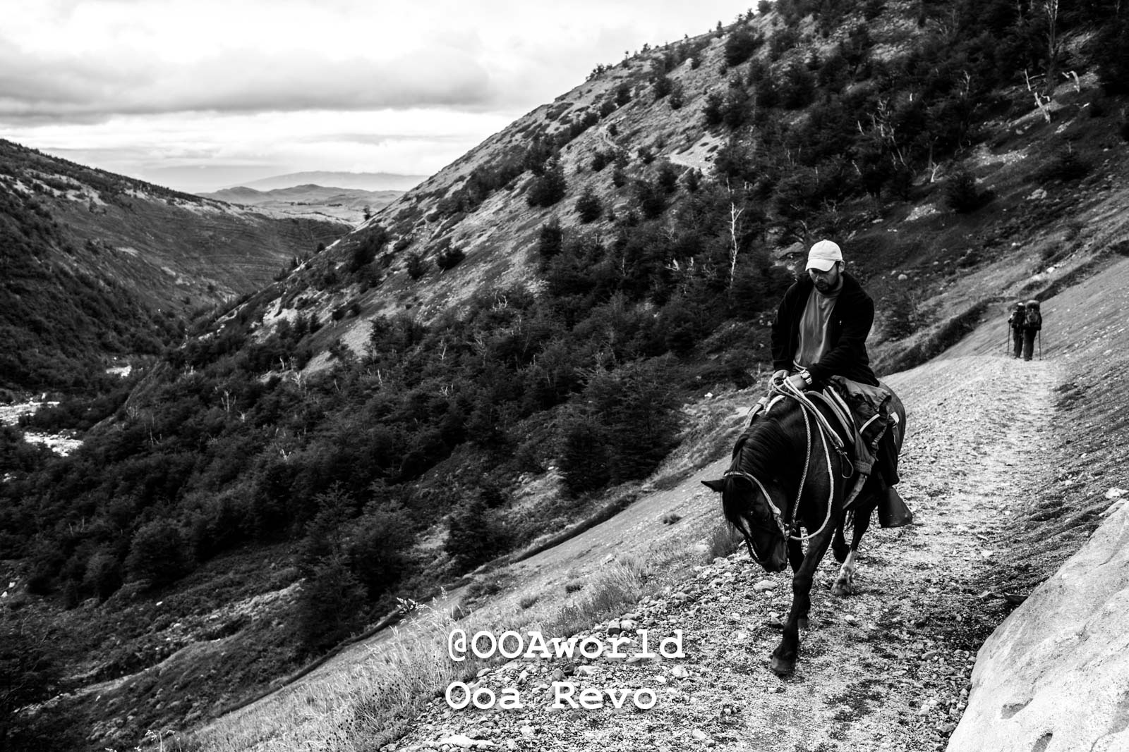 Torres Del Paine Day 4 End of Trek Torres Del Paine Trek man riding horse on mountain trail black and white Photo OOAworld