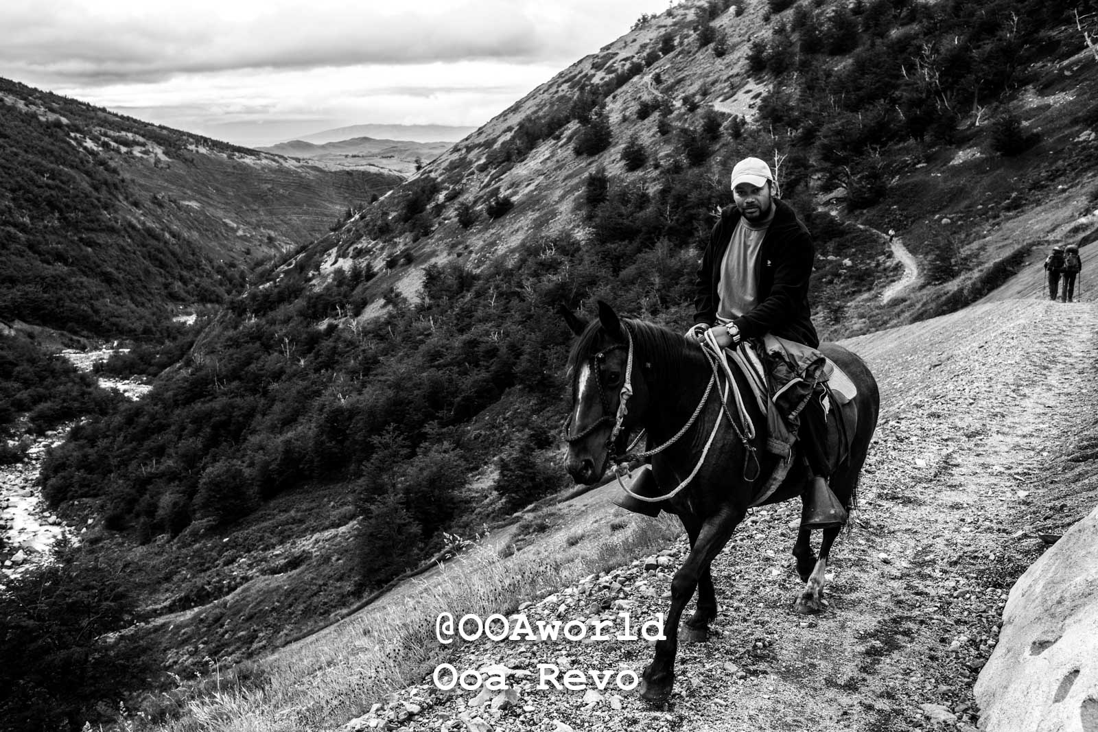 Torres Del Paine Day 4 End of Trek Torres Del Paine Trek man riding horse in mountainous landscape black and white Photo OOAworld